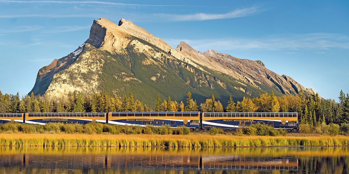 Rocky Mountaineer train riding past mountains in Canada