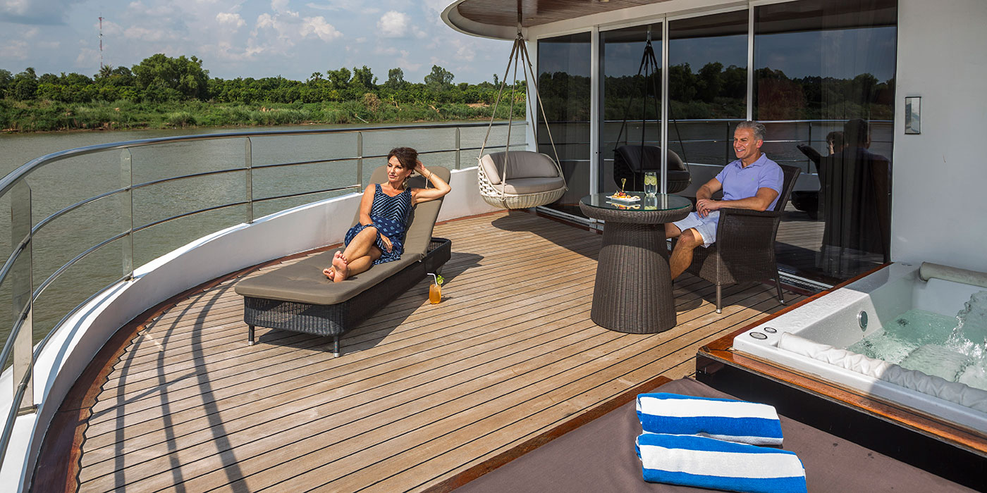 Guests on the outdoor terrace of the Panorama Suite on board Scenic Spirit
