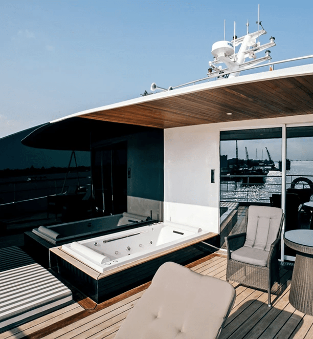 An outdoor Jacuzzi and seating area on the terrace of the Royal Panorama Suite