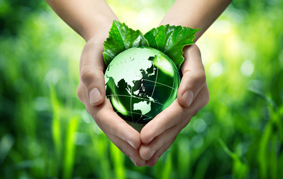 Image composition of hands holding a green Earth