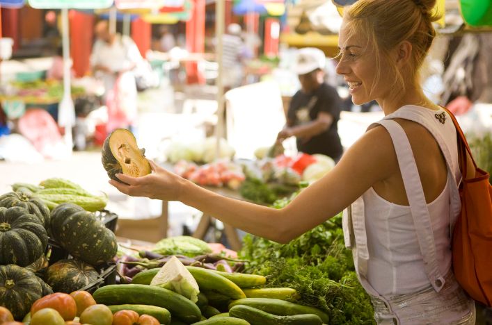Woman shopping at colourful outdoor market
