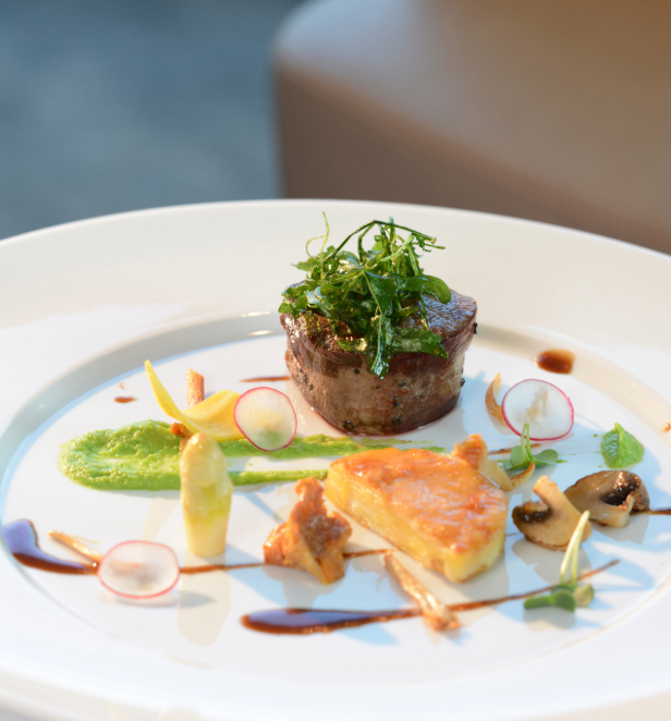 A pristine white plate elegantly arranged with gourmet food, showcasing a delightful culinary presentation.