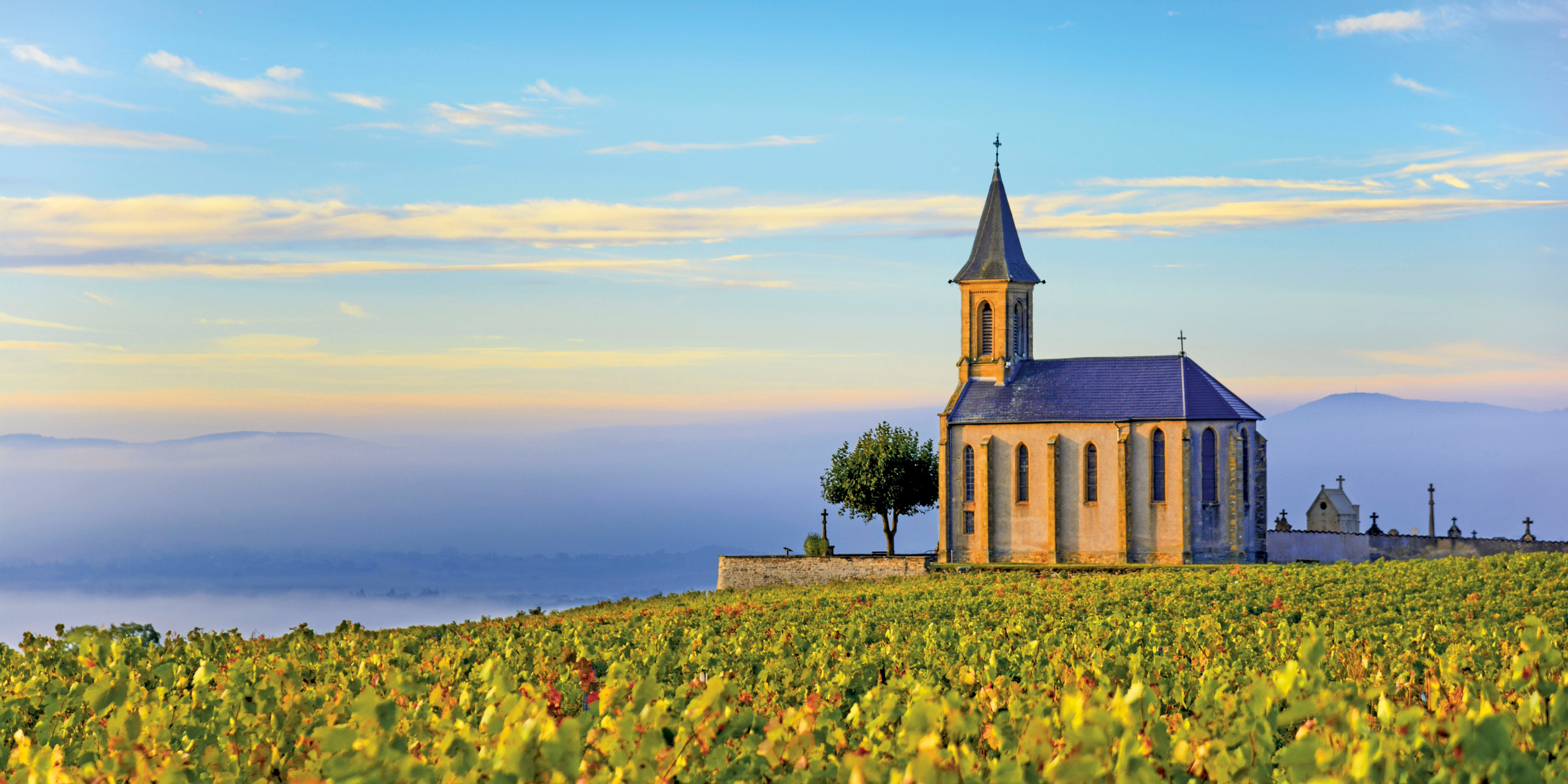 Beaujolais scenery with church and vibrant blue skies