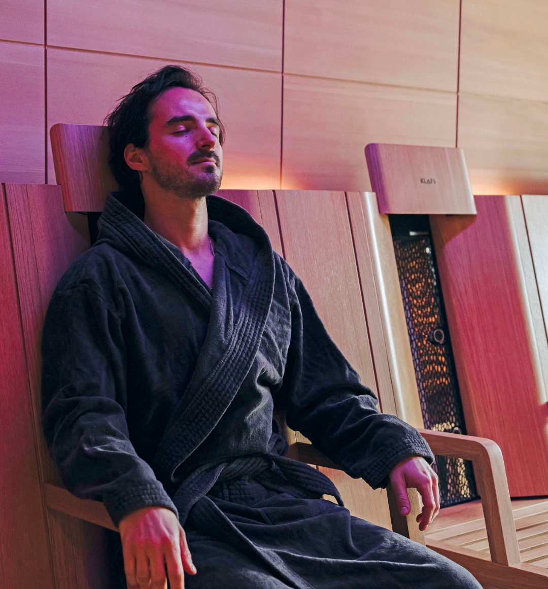 Man relaxing in ambient lit spa room