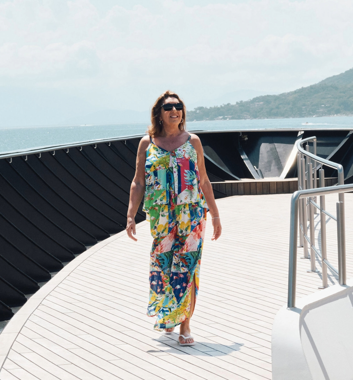 Jane McDonald on board the Scenic Eclipse with the sun beaming behind her. 