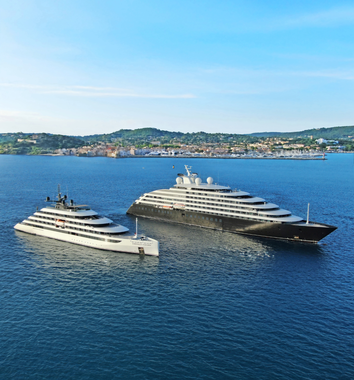 Scenic Eclipse and Emerald Sakara Star-Ships sailing alongside one another. 