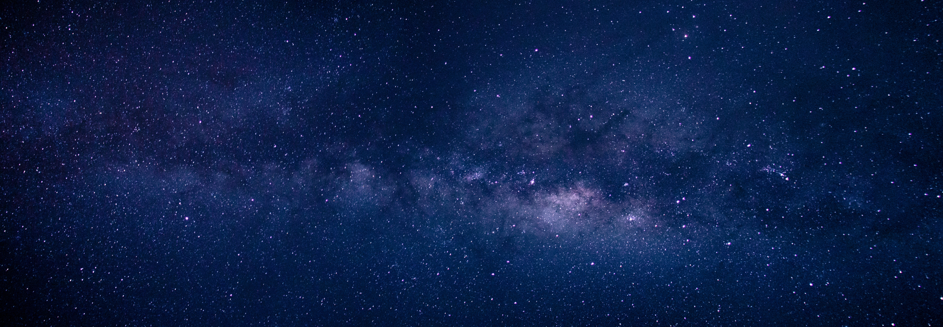 A stunning view of the Milky Way stretching across a dark night sky.
