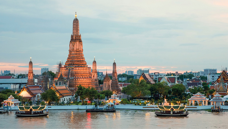 Bangkok by the water, Wat Arun temple lit up at sunset. 