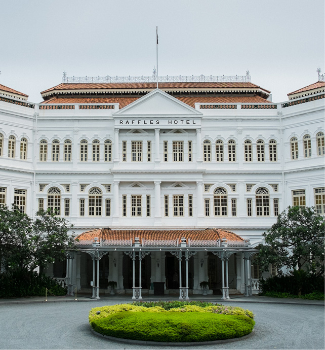 White facade of the british colonial-style luxury hotel “ Ruffles Hotel” in Singapore