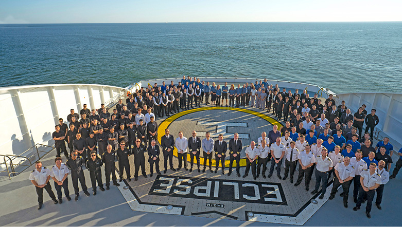 Ocean ship crew standing on the helicopter landing pad 