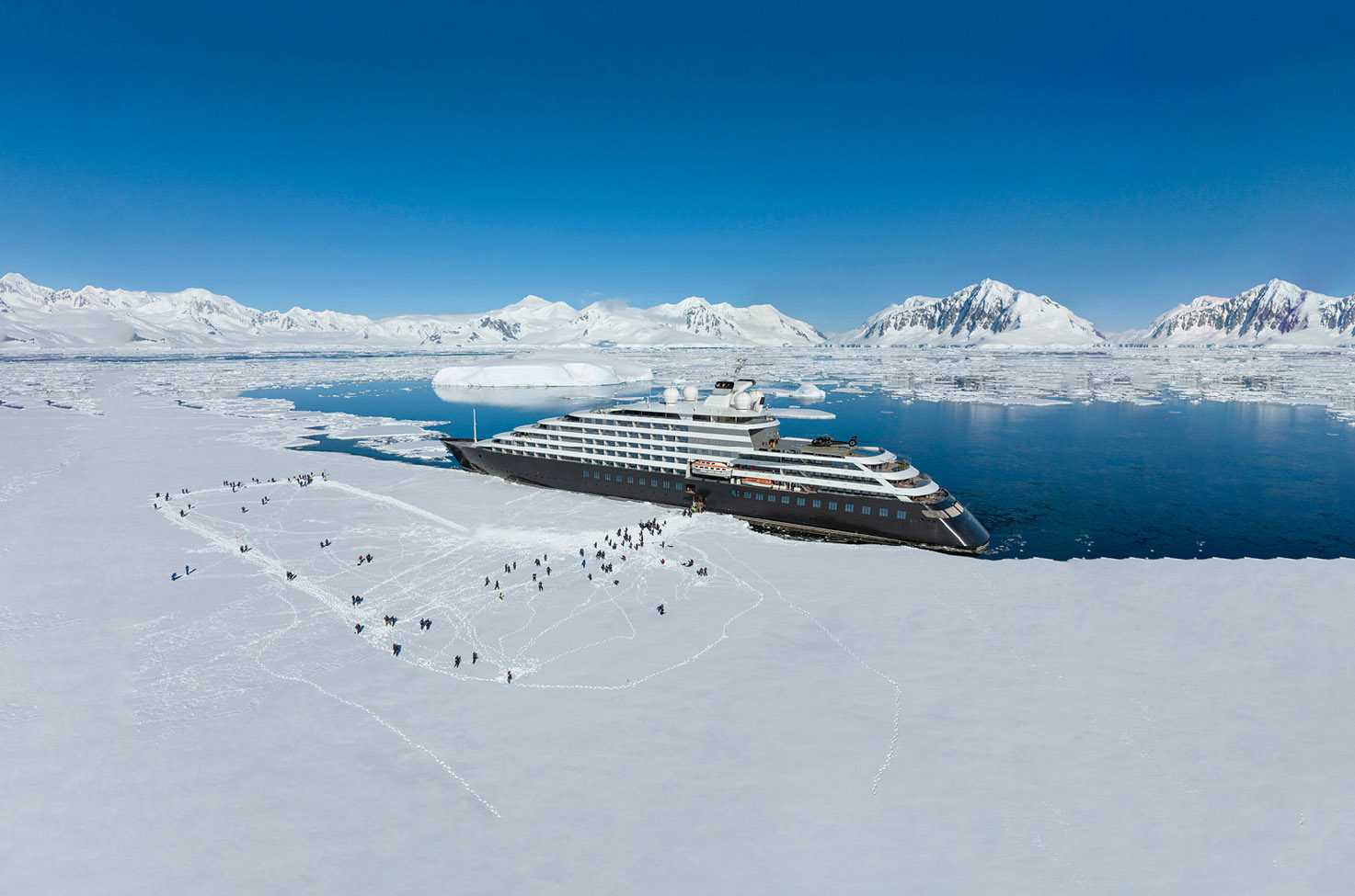 Luxury ocean cruising ship docked next to the ice in Antarctica