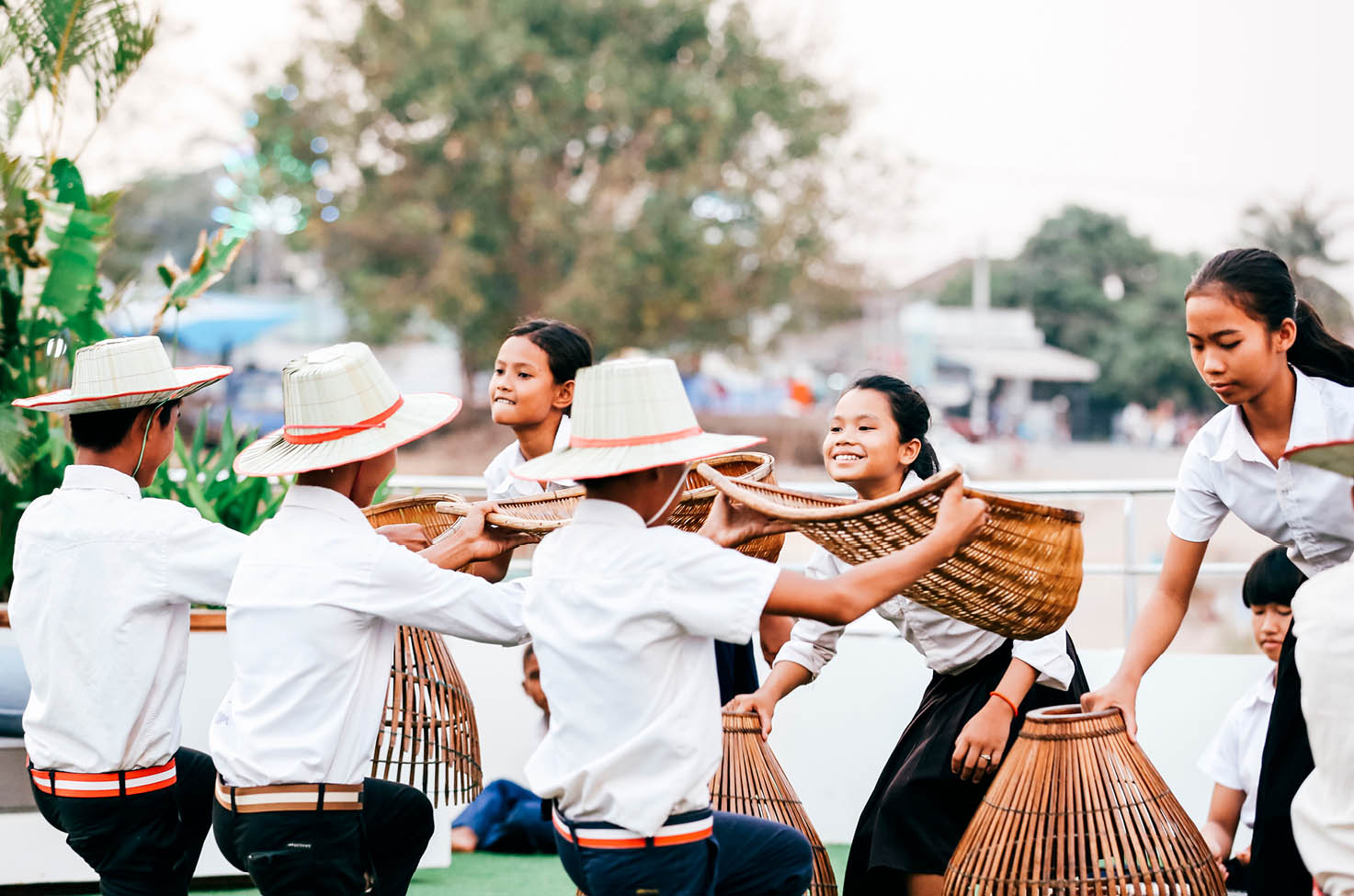 Group of people wearing white weaving baskets