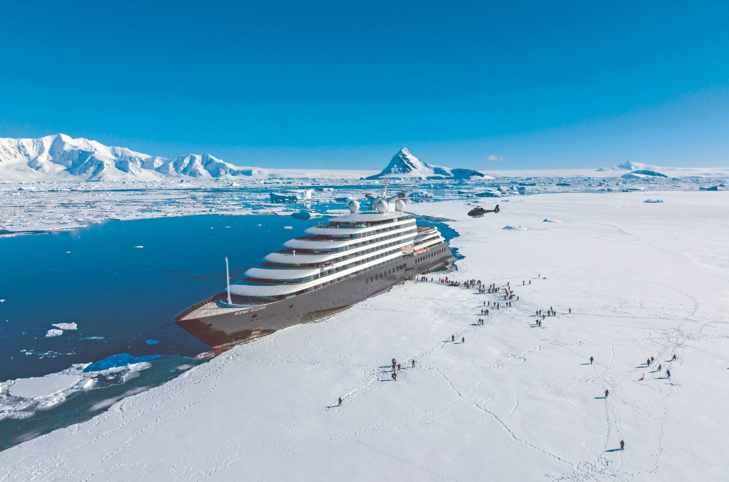 luxury yacht ship docked next to ice sheet